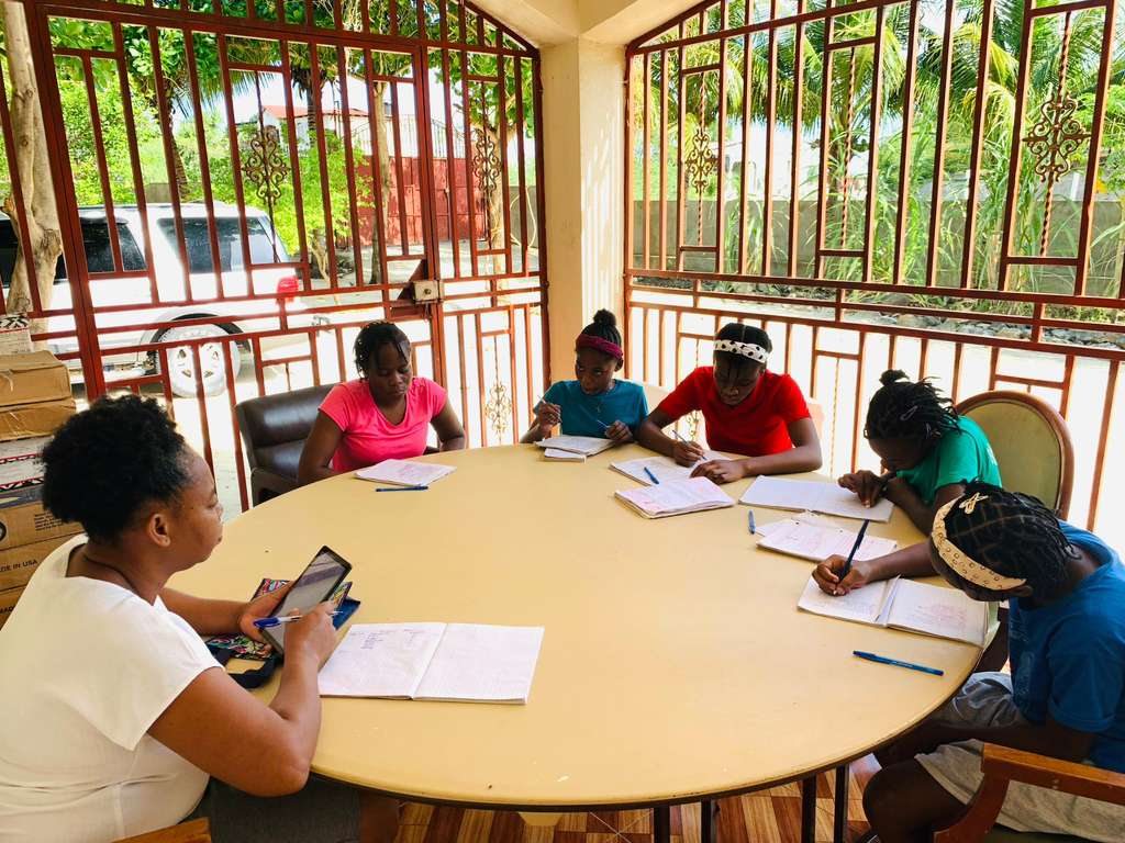 Students and teachers around a classroom table