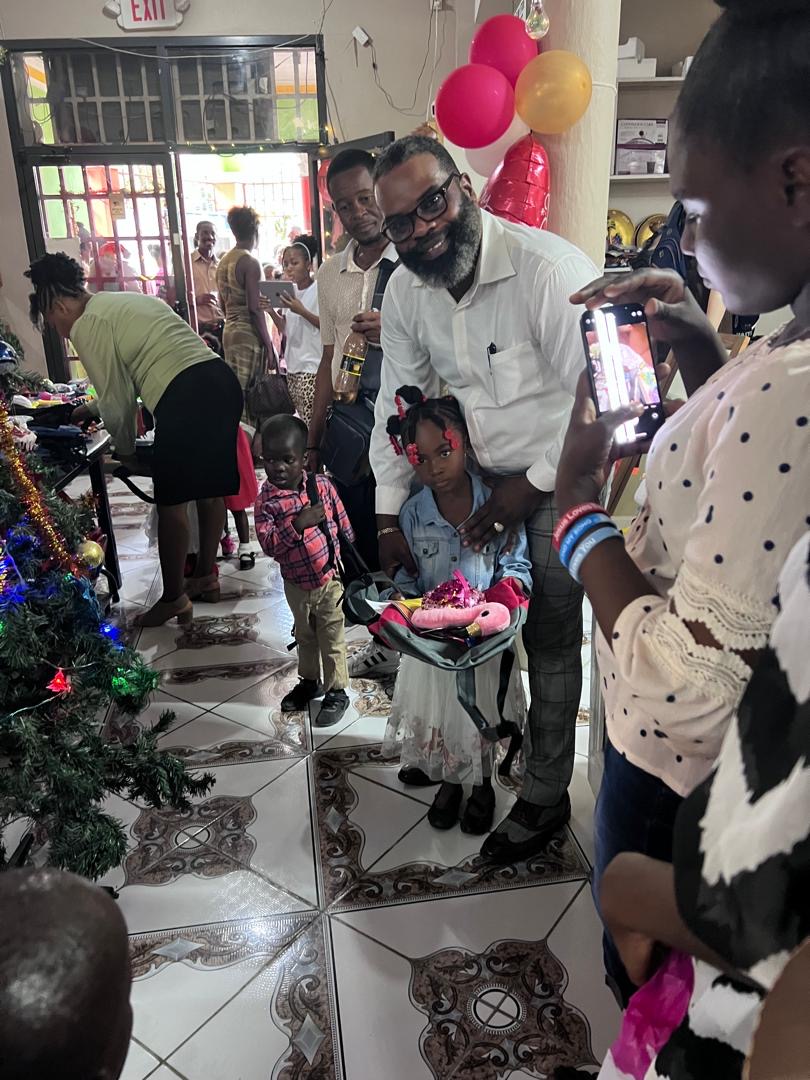 Family photo moment as children receive gifts