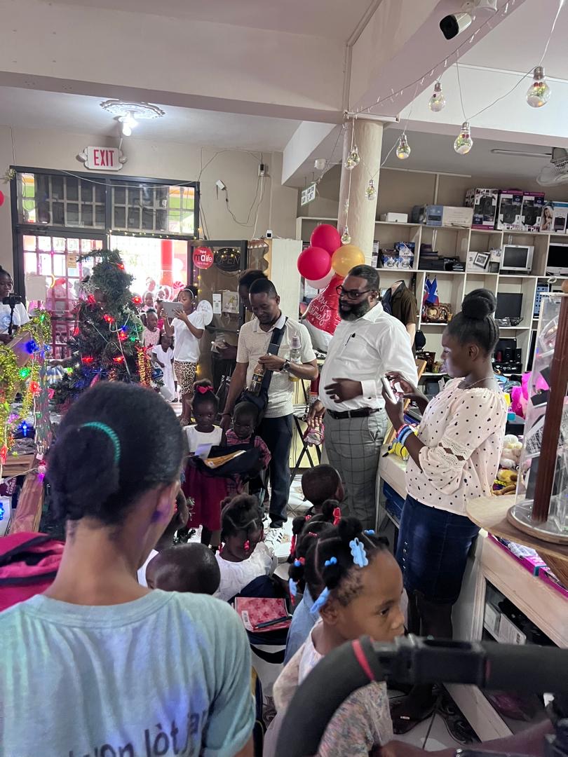 Children gathered around the Christmas tree during the distribution
