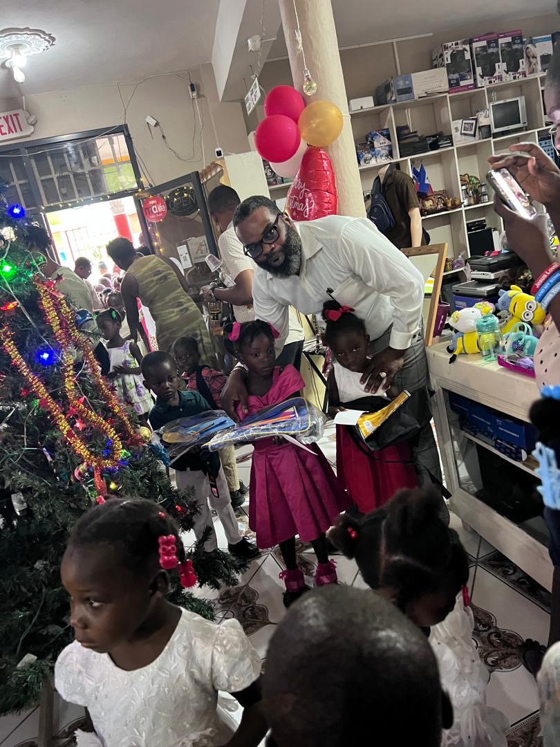 Children in uniform receiving school kits and supplies