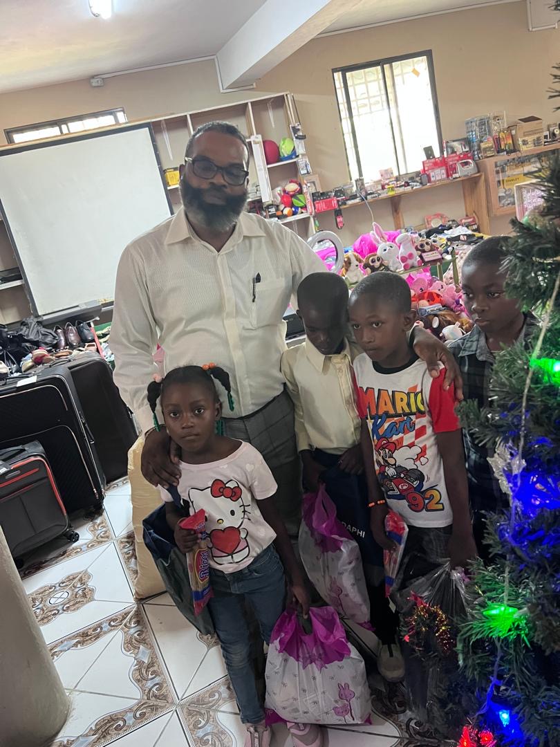 Pastor with a group of children holding their gift bags