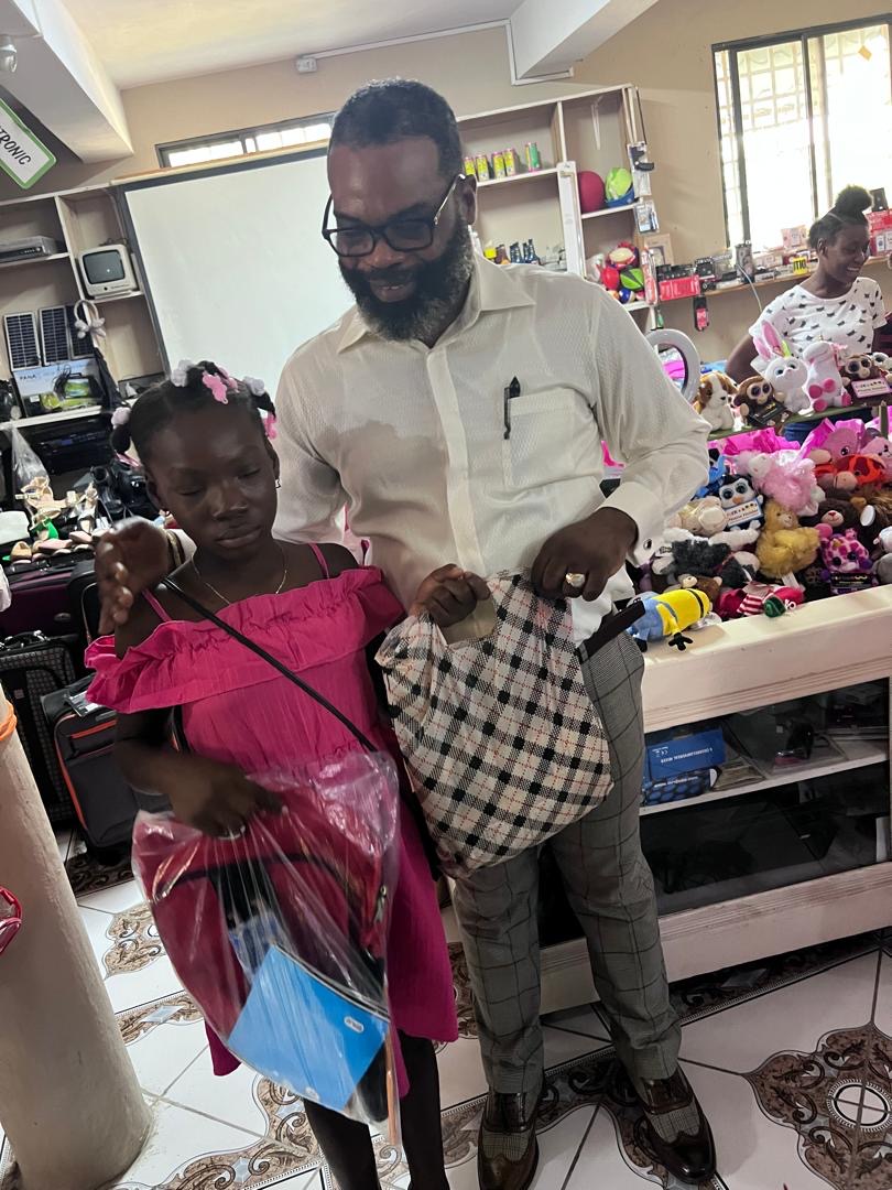 Young girl receiving a backpack and school supplies