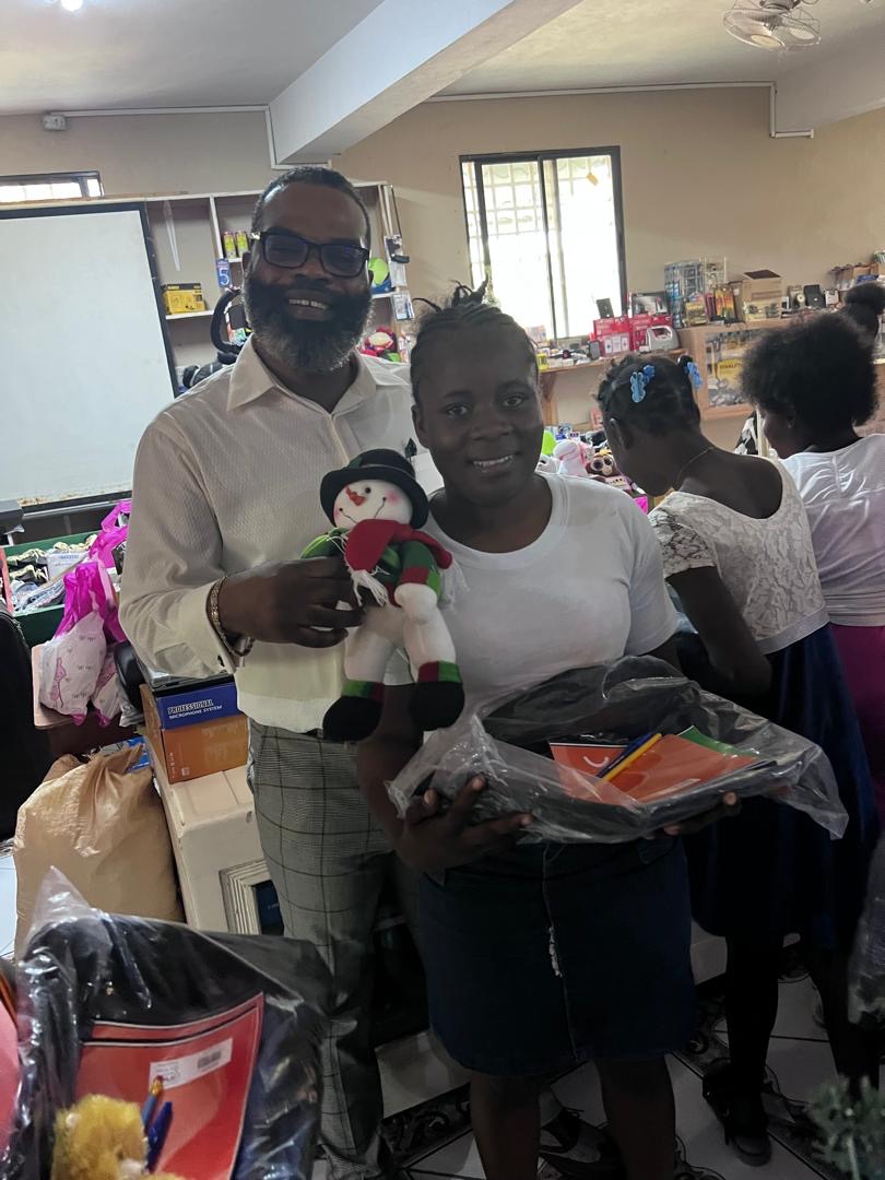 Young woman receiving school supplies and a snowman plush