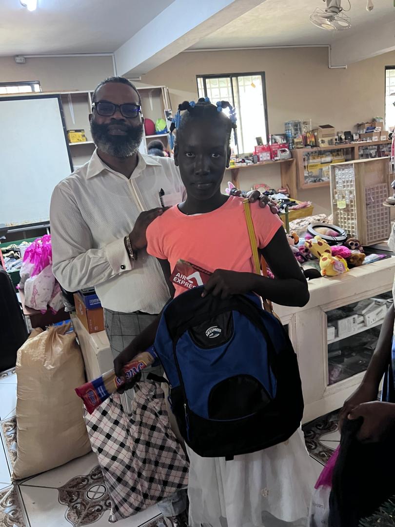 Teen girl receiving a new backpack and snacks