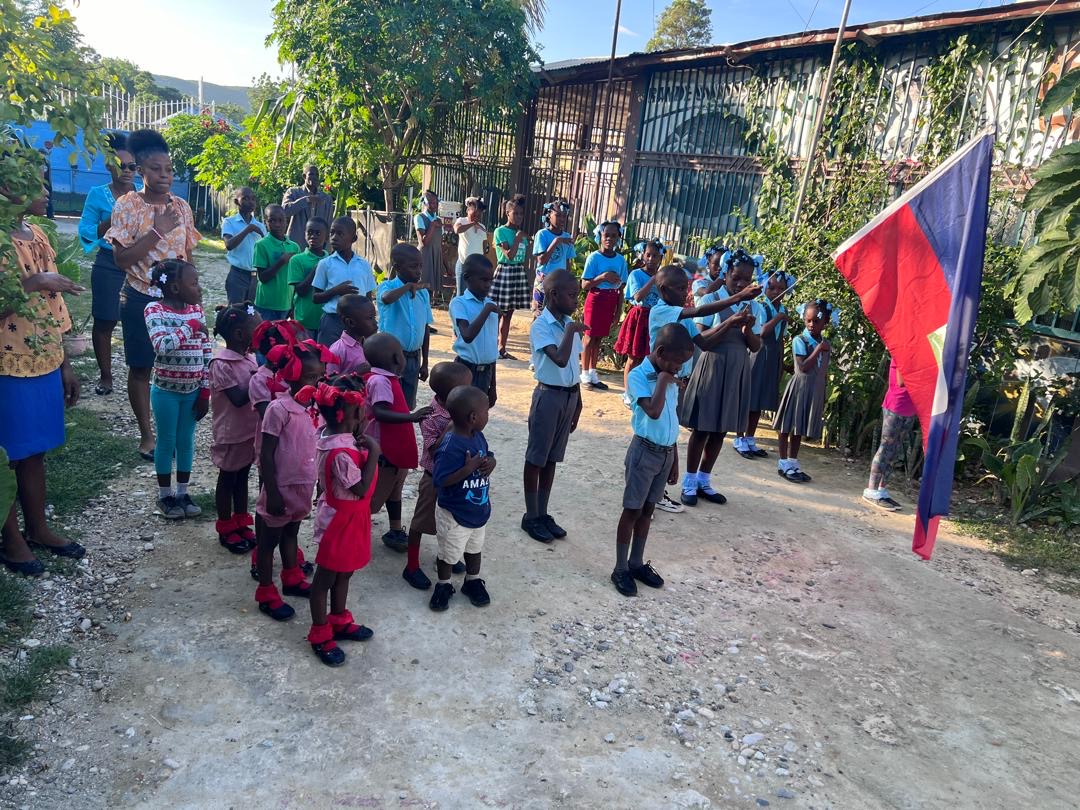 Morning assembly with the Haitian flag at SCH school